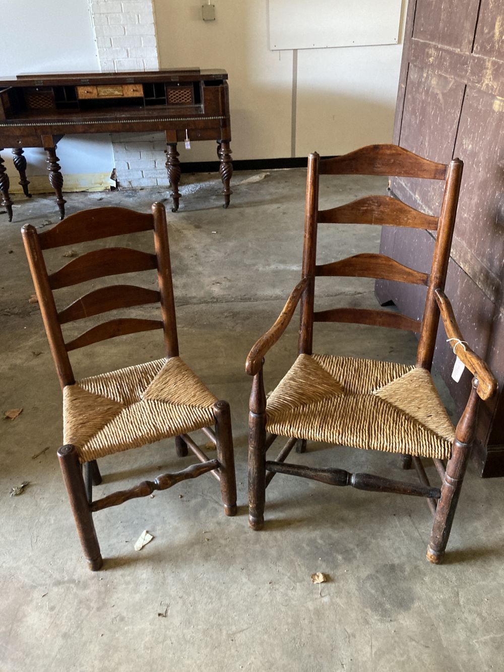A set of eight rush seat ladderback dining chairs (two with arms)